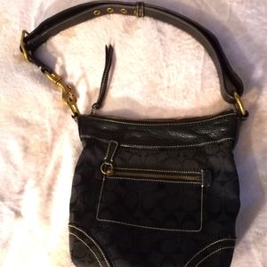 Small coach shoulder bag with belt strap.